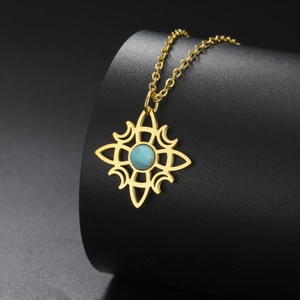 Detail of gold Celtic witch knot necklace with turquoise stone inlay on black display