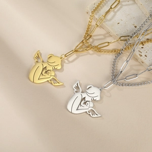 Detail of cupid gold and silver necklaces with mother and child pendant on paperclip chain
