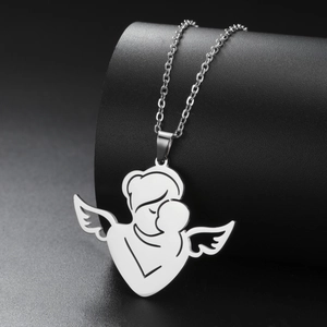 Macro detail of polished stainless steel mother and child angel pendant on jewelry display
