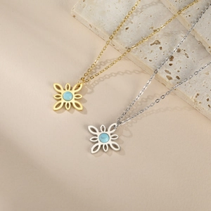 Detailed macro view of gold and silver witch knot necklaces with blue stones