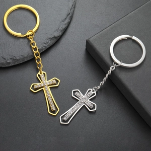 Detailed macro view of gold and silver cross keychains with crystal rhinestones