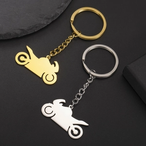 Polished 304 stainless steel motorcycle keychains in gold and silver finish on black background