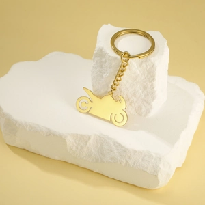Detail of a gold motorcycle silhouette keychain in polished 304 stainless steel