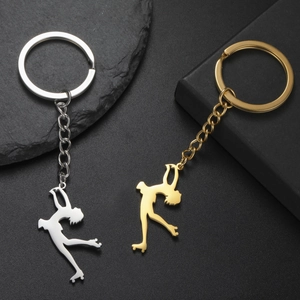 Détails des porte-clés silhouettes de patineur artistique en argent et or sur fond texturé