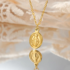 Golden oval Miraculous Medal necklace for women with Virgin Mary relief and fine link chain