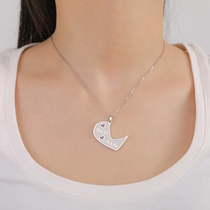 Polished stainless steel BIG SIS necklace with half-heart pendant and heart cutouts