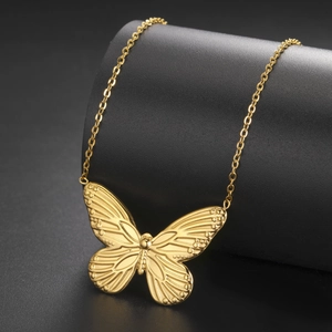 Eleganter goldener Schmetterlingsanhänger Halskette mit feinen Flügelstrukturen auf Sockel