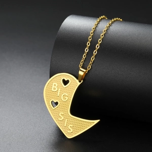 Close-up of gold stainless steel necklace with Big Sis engraved heart pendant