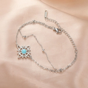Detail eines Keltenknoten-Armbands mit blauem Türkisstein und Edelstahl-Anhängern