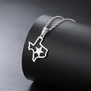 Detail shot of Texas map pendant with cutout star on sleek silver stainless steel chain