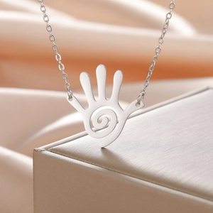 Silver stainless steel necklace with spiral hollow palm pendant on champagne silk background