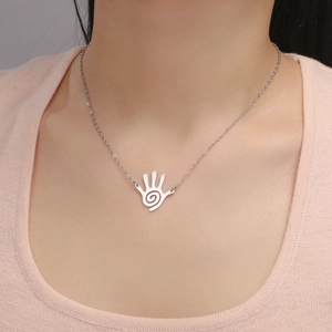 Minimalist silver stainless steel hand pendant necklace with spiral palm pattern on model