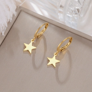 Elegant gold stainless steel star drop earrings with polished finish on a luxury background