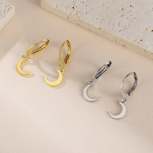 Detailed view of gold and silver stainless steel hoop earrings with crescent moon charms