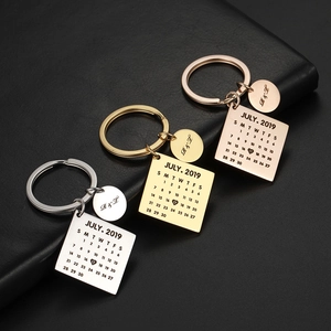 Custom calendar keychain in gold and silver finish with personalized engraved wedding date