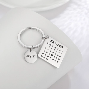 Detailed view of silver stainless steel calendar keychain with heart-marked wedding date