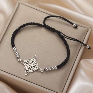 Detail of adjustable black woven rope bracelet with polished Celtic knot pendant and beads