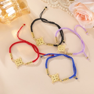 Set of four colorful woven bracelets with golden Celtic knot charms on beige background