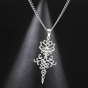 Detailed view of silver hollow lotus and unalome pendant on stainless steel chain