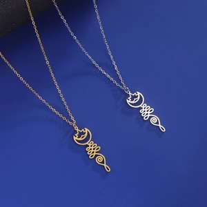 Detail view of gold and silver hollowed lotus unalome necklaces on blue textured surface