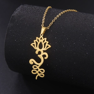 Detail of gold stainless steel lotus necklace with Om and Unalome sacred symbols