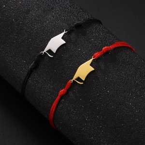 Close-up of woven graduation cap bracelets in black-silver and red-gold color options