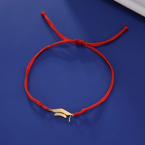 Detail of red woven graduation cap bracelet with golden stainless steel charm