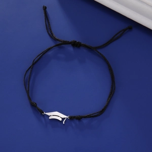 Close-up of black braided graduation cap bracelet with polished stainless steel charm