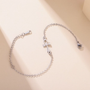 Detail of stainless steel bracelet featuring an Ankh cross pendant and S.STEEL hallmark