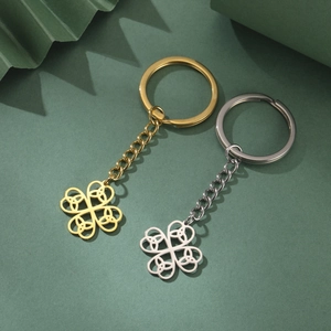 Golden and silver stainless steel four-leaf clover keychain with celtic knot cutout