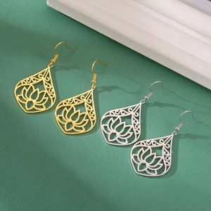 Detailed macro of gold and silver lotus teardrop earrings with intricate cutout designs