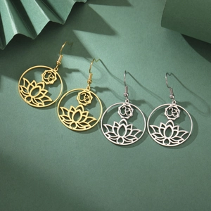 Detailed macro view of gold and silver hollow lotus yoga earrings with Om symbols