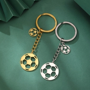 Close-up of gold and silver soccer ball keychains with hollow metal soccer pendants