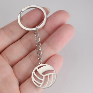 Detailed macro view of a silver hollow-out volleyball pendant with durable metal keychain