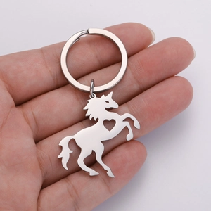 Close-up of polished 304 stainless steel unicorn keychain with hollow heart design