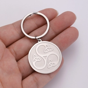 Close-up of matte silver stainless steel keychain with Celtic Triskele knot engraving