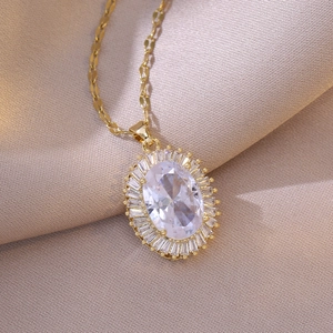 Elegant gold titanium steel necklace with oval white zircon sunflower pendant on silk background