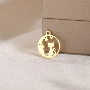Detailed view of a gold celestial cat and moon pendant for DIY jewelry making