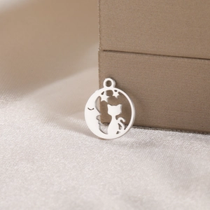 Macro shot of a silver cat and moon hollow pendant made of polished stainless steel