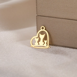 Macro shot of gold heart pendant with three cat silhouettes on elegant silk background