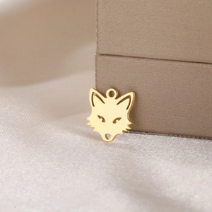 Macro view of a golden fox shaped stainless steel pendant for DIY jewelry making