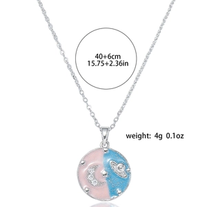 Detail of freshwater pearl necklace with crescent moon and planet enamel pendant charms