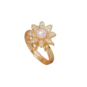 Elegant gold flower ring featuring a central white pearl and sparkling zircon petals