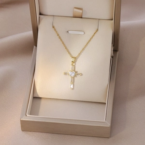 Fashionable gold cross necklace with heart and rectangular zircon stones in jewelry box