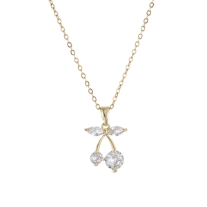 Detailed close-up of golden cherry pendant with sparkling zircon stones and fine gold chain