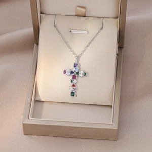 Detail shot of multi-color zircon cross necklace displayed in a luxury gift box