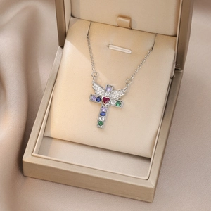 Silver cross necklace with colorful zircons and a red heart stone on champagne silk