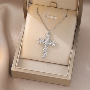 Detail view of cross pendant necklace with round clear zircons in a premium jewelry box