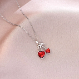 Minimalist cherry necklace with heart-shaped red crystals and sparkling silver leaves