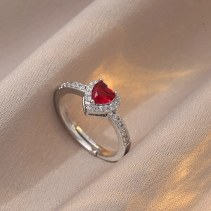 Adjustable silver heart ring with large red zircon gemstone and halo diamond setting